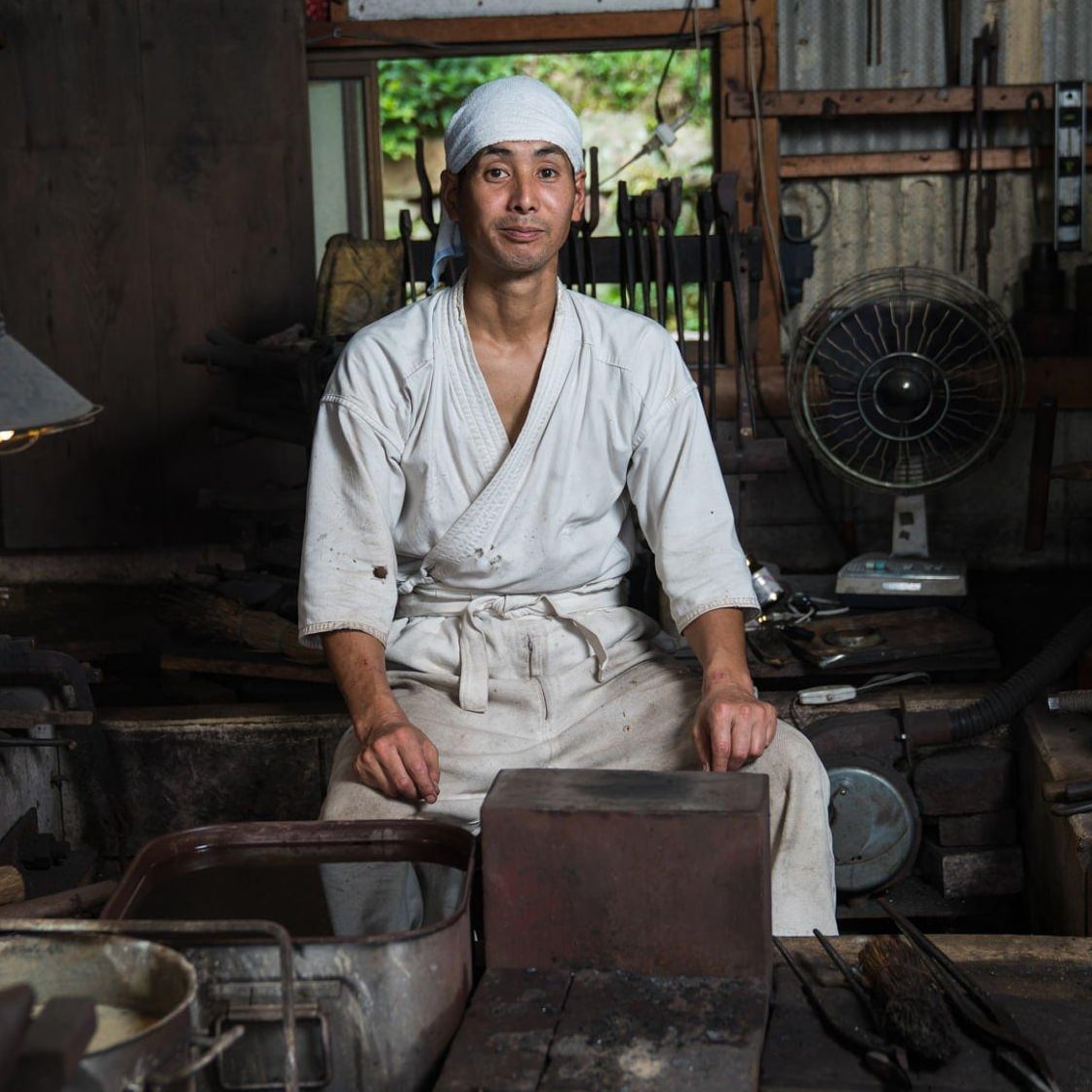 Swordsmith working in a traditional workshop